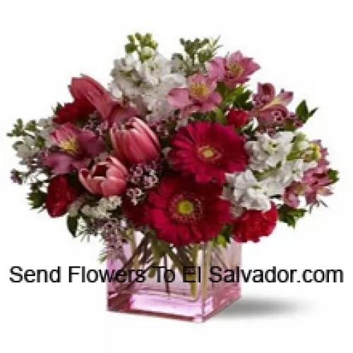 Red Roses, Red Tulips And Assorted Flowers With Seasonal Fillers Arranged Beautifully In A Glass Vase