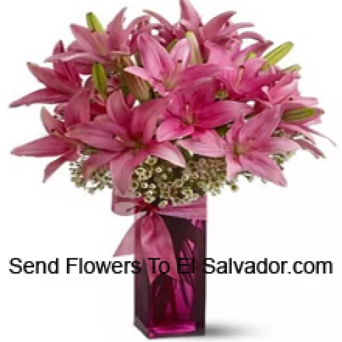 Beautiful Pink Lilies With Some Ferns In A Glass Vase