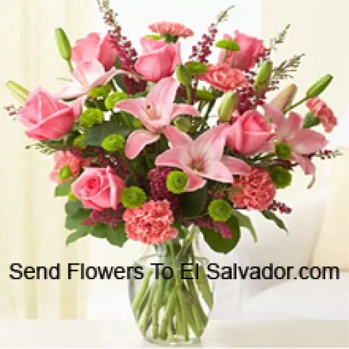 Pink Roses, Pink Carnations And Pink Lilies With Assorted Ferns And Fillers In A Glass Vase