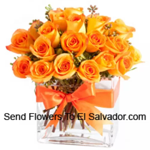 24 Orange Roses With Some Ferns In A Glass Vase