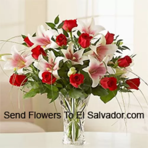 Red Roses And Pink Lilies With Seasonal Fillers In A Glass Vase