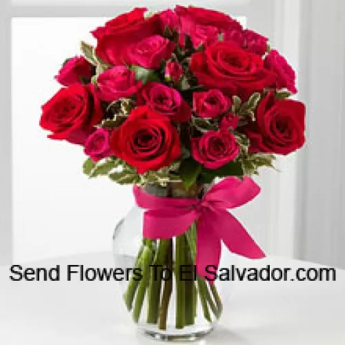 18 Red Roses With Seasonal Fillers In A Glass Vase Decorated With A Pink Bow