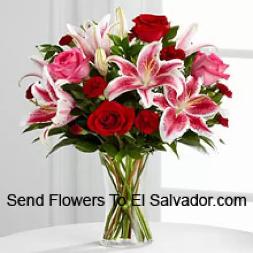 Red And Pink Roses With Pink Lilies And Seasonal Fillers In A Glass Vase