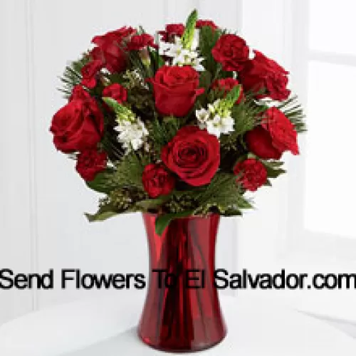 This romantic arrangement bristles with the passion and wonder of the Christmas season. Rich red roses and burgundy mini carnations accented with the snowy white blooms of Stars of Bethlehem, pine branches, and lush greens will easily sweep them off their feet. Arranged in a ruby red clear glass vase, this bouquet conveys your most heartfelt holiday wishes. (Please Note That We Reserve The Right To Substitute Any Product With A Suitable Product Of Equal Value In Case Of Non-Availability Of A Certain Product)