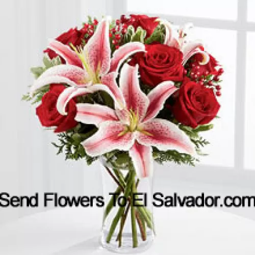 This Bouquet is a simply stunning display of seasonal glamour they won't be able to resist. Rich red roses are paired with the dazzling beauty of Stargazer lilies accented with holiday greens, berry sprays and a bordeaux satin rbbon for an elegant look. Arranged in a clear glass vase, this bouquet will add to the magic and wonder of their holiday festivities. (Please Note That We Reserve The Right To Substitute Any Product With A Suitable Product Of Equal Value In Case Of Non-Availability Of A Certain Product)