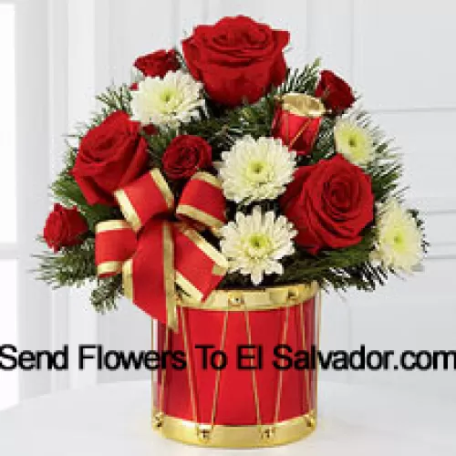 A blossoming display of seasonal merriment and festive greetings. Rich red roses and spray roses sweetly mingle with white chrysanthemums arranged amongst lush holiday greens, all perfectly accented with drum pics and a gold-edged red ribbon. Arriving in a designer red and gold drum inspired vase, this bouquet will express your most heartfelt wishes for a wonderful holiday season. (Please Note That We Reserve The Right To Substitute Any Product With A Suitable Product Of Equal Value In Case Of Non-Availability Of A Certain Product)